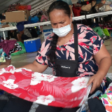 Women-of-the-Church-in-action-folding-and-preparing-clothes-to-pack-in-boxes-at-the-collection-center-for-the-Fiji-solidarity-project.-French-Polynesia,-December-2020