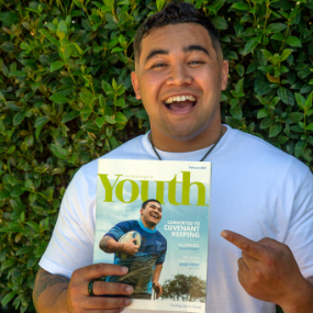 Awa-Morris-shows-the-cover-of-the-February-2022-issue-of-'For-the-Strength-of-Youth'-magazine-that-includes-an-article-about-his-recent-mission-experiences-in-the-Philippines,-the-USA-and-in-New-Zealand.-the-article,-Awa-talks-about-how-his-mission-helped-him-learn-to-keep-covenants-with-God.