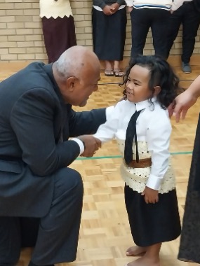 Elder Taniela B. Wakolo greets a young boy after a sacrament meeting in Tamaki, Auckland. 12 March 2023. 