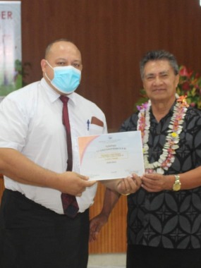 Honourable Leota Laki Lamositele, Minister of Women, Community and Social Development presents a certificate to Muagututia H. Jason Joseph, president of the Apia Samoa Central Stake as part of the 'Beautiful Samoa' campaign.