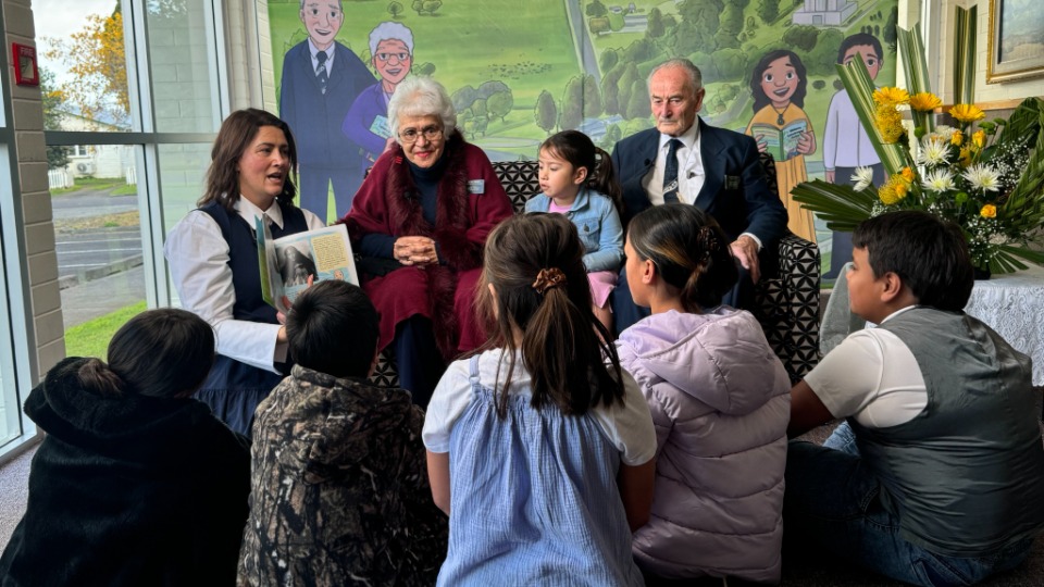 Children listen to a reading of the new Church history book in Kaikohe New Zealand.