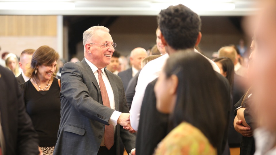 Elder Ulisses Soares greets young people at a devotional in Sydney, Australia on 10 March 2023.