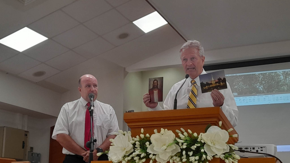 Elder-K.-Brett-Nattress-holds-up-a-picture-of-the-Saviour,-Jesus-Christ-and-the-temple-in-a-meeting-with-New-Caledonian-Latter-day-Saints-held-in-February,-2023.