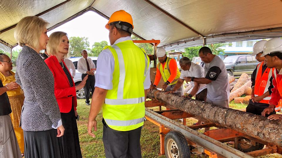 Sister Joy Jones and Sister Bonnie Cordon at sawmill in Tonga.