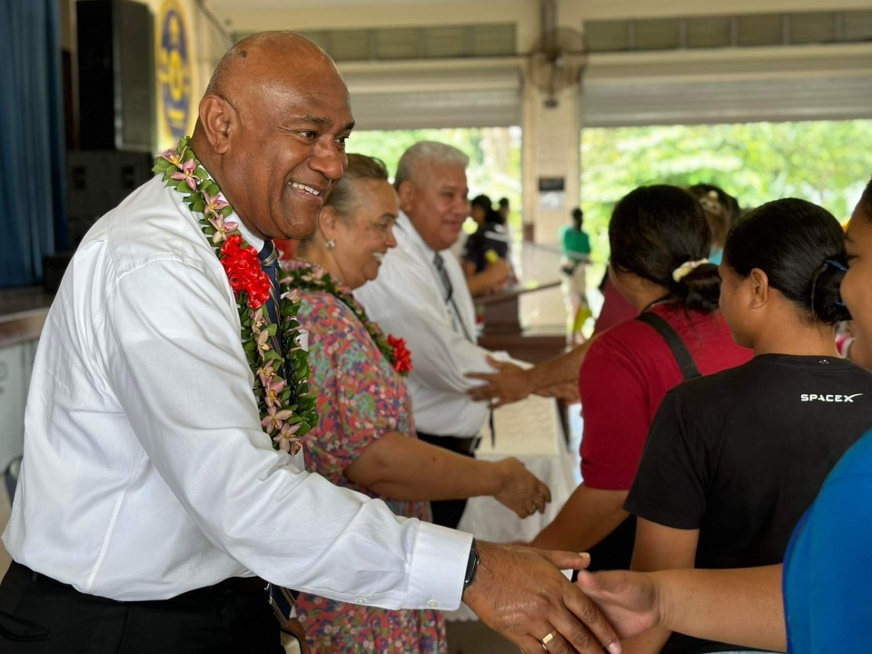 Elder Wakolo greets young adults in Samoa. July 2023.
